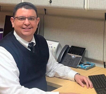 Dr. Carlos Ventura sitting at his desk