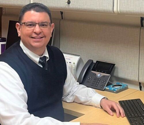 Dr. Carlos Ventura sitting at his desk