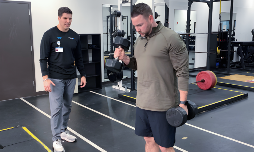 Rex Carpenter coaching a man lifting weights to help him reach his fitness goals