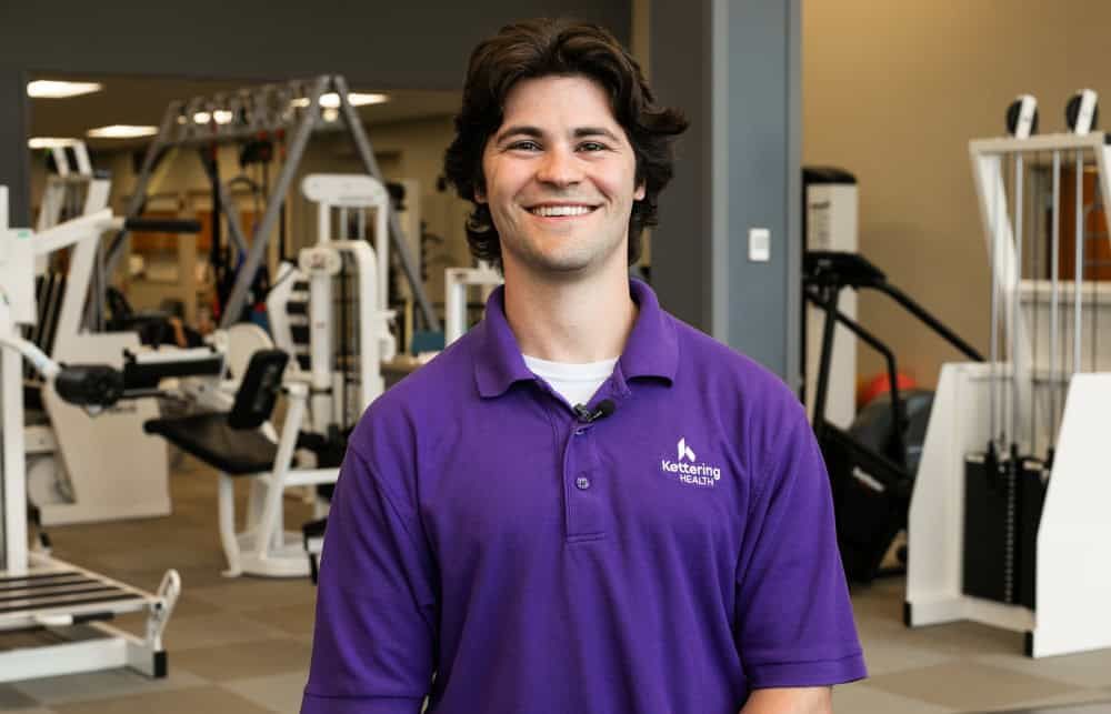 physical therapist Aaron Cingle smiles at camera in gym