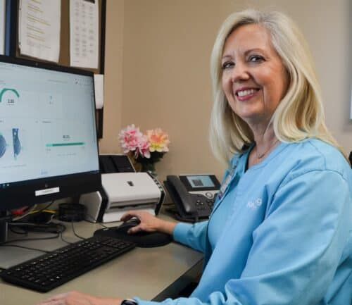 Mammography technologist Teresa Young showing Volpara Health AI Technology on computer screen