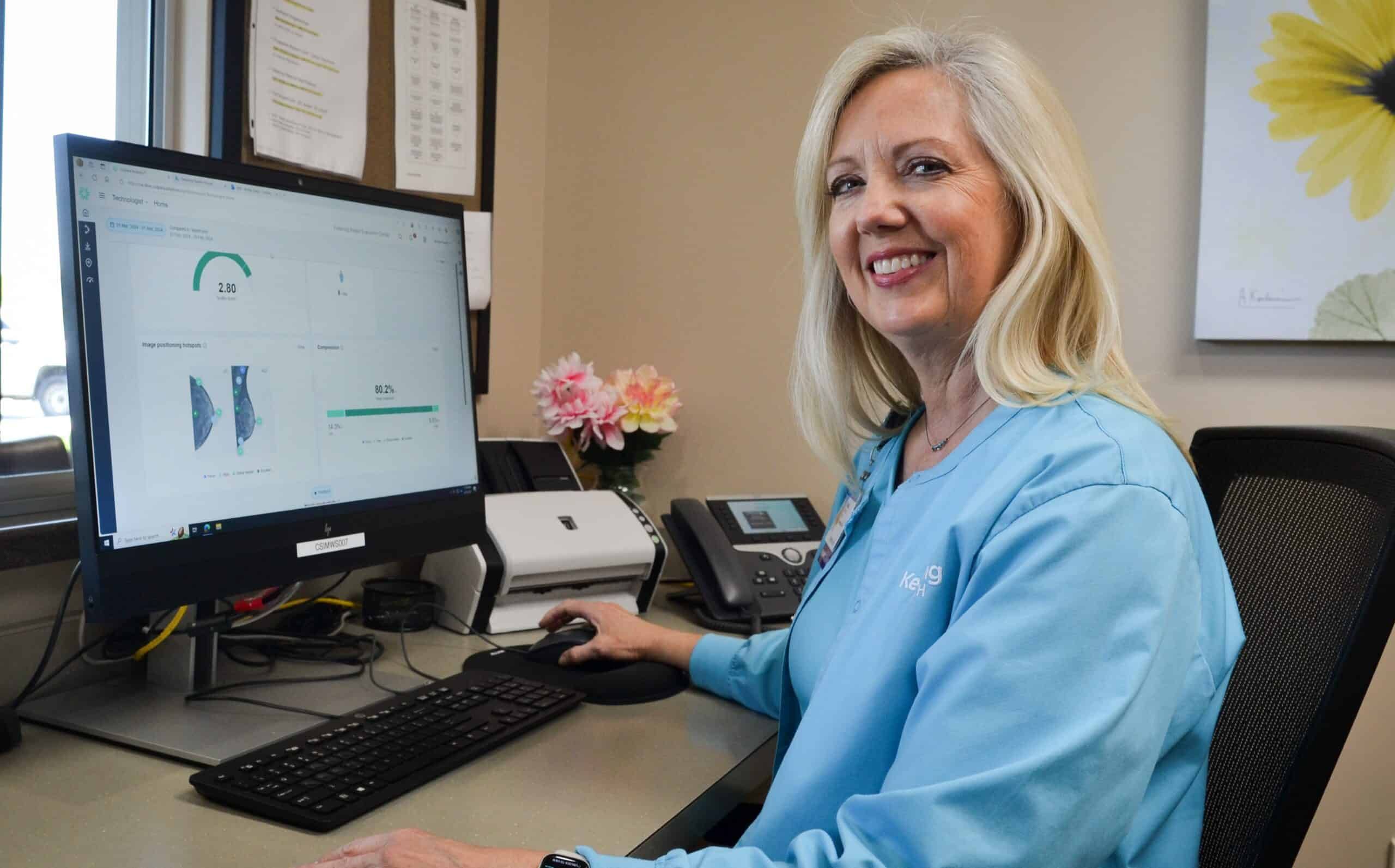 Mammography technologist Teresa Young showing Volpara Health AI Technology on computer screen
