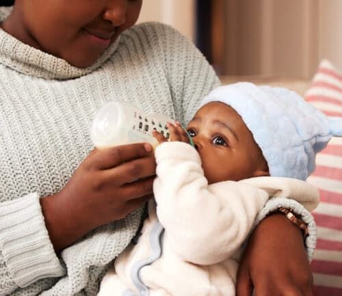 Mother feeding baby with bottle