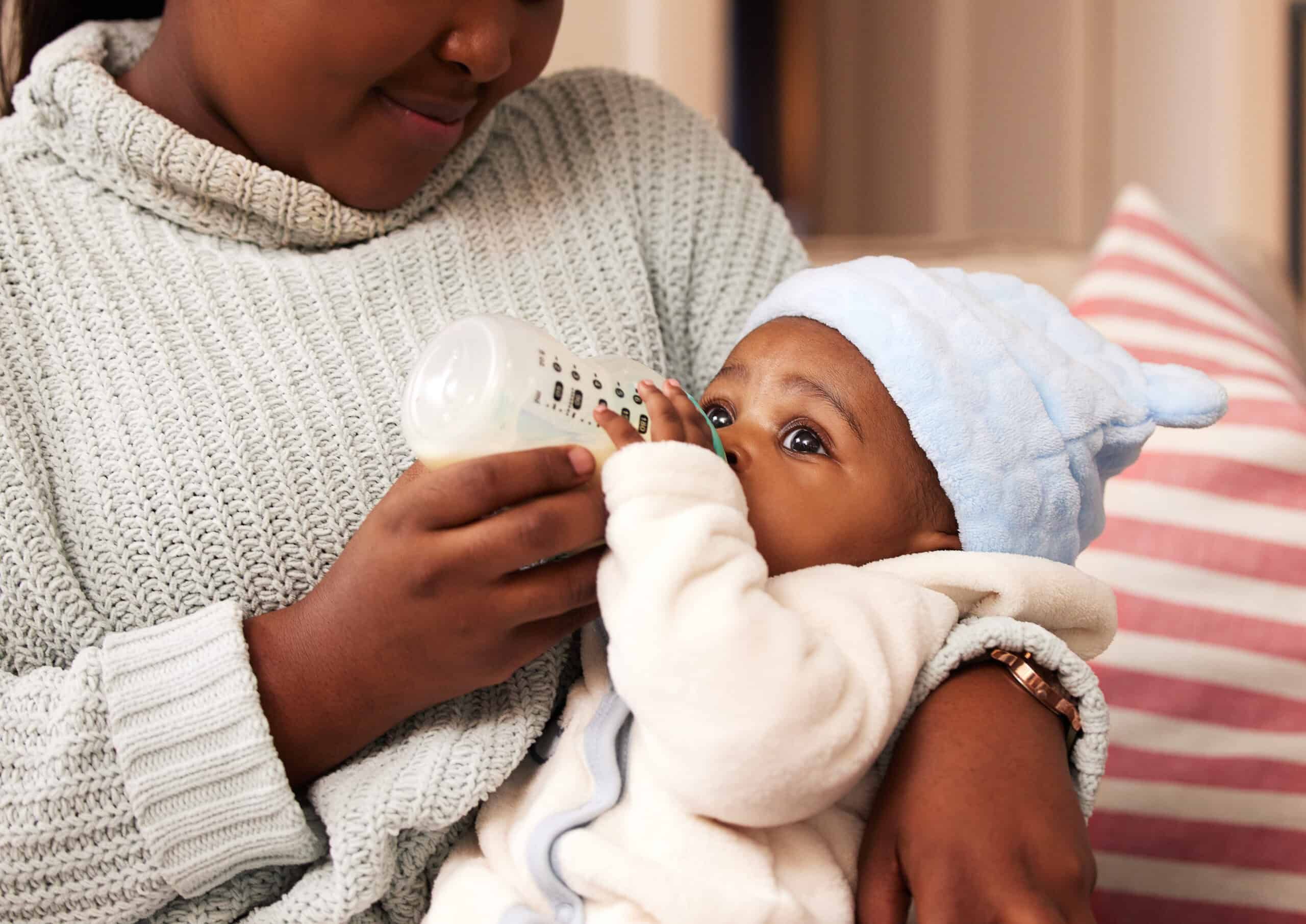 Mother feeding baby with bottle