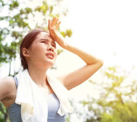 Woman gets tired while exercising in the heat