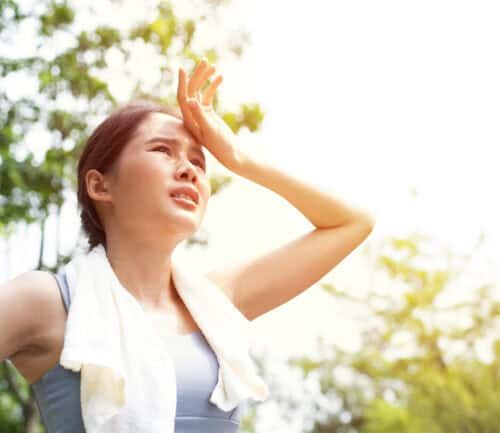 Woman gets tired while exercising in the heat