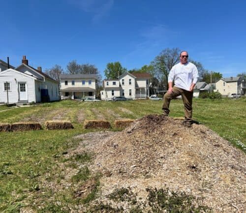 Bruce Kidney standing on dirt mound in unity garden