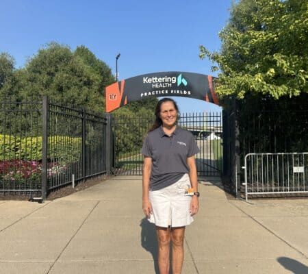 Dr. Cindy Cassell in front of practice fields