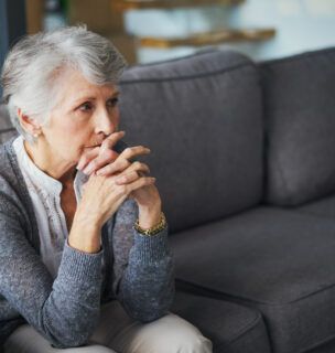 Shot of a senior woman suffering from stress at home