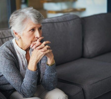 Shot of a senior woman suffering from stress at home