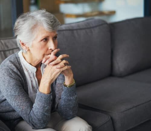 Shot of a senior woman suffering from stress at home