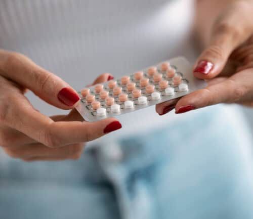 Woman holding a birth control packet