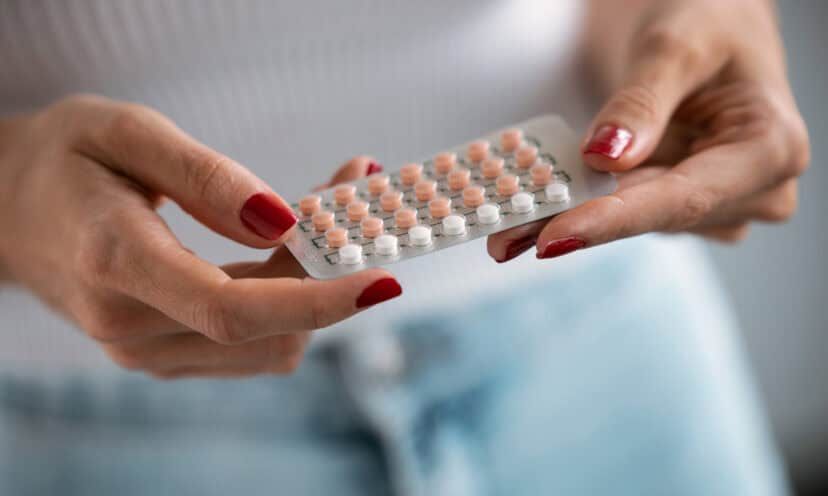 Woman holding a birth control packet