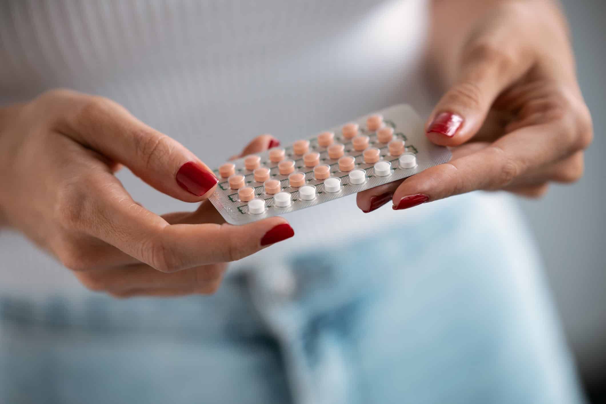 Woman holding a birth control packet