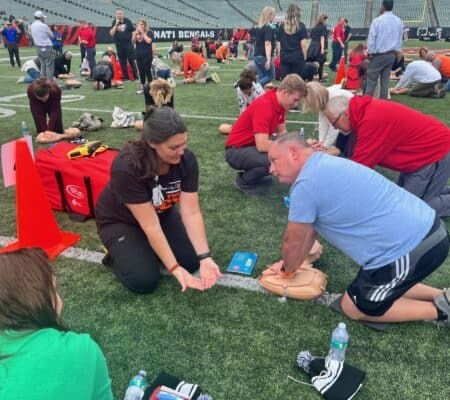 Woman learning CPR at Save the Dey event