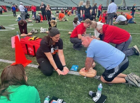 Woman learning CPR at Save the Dey event