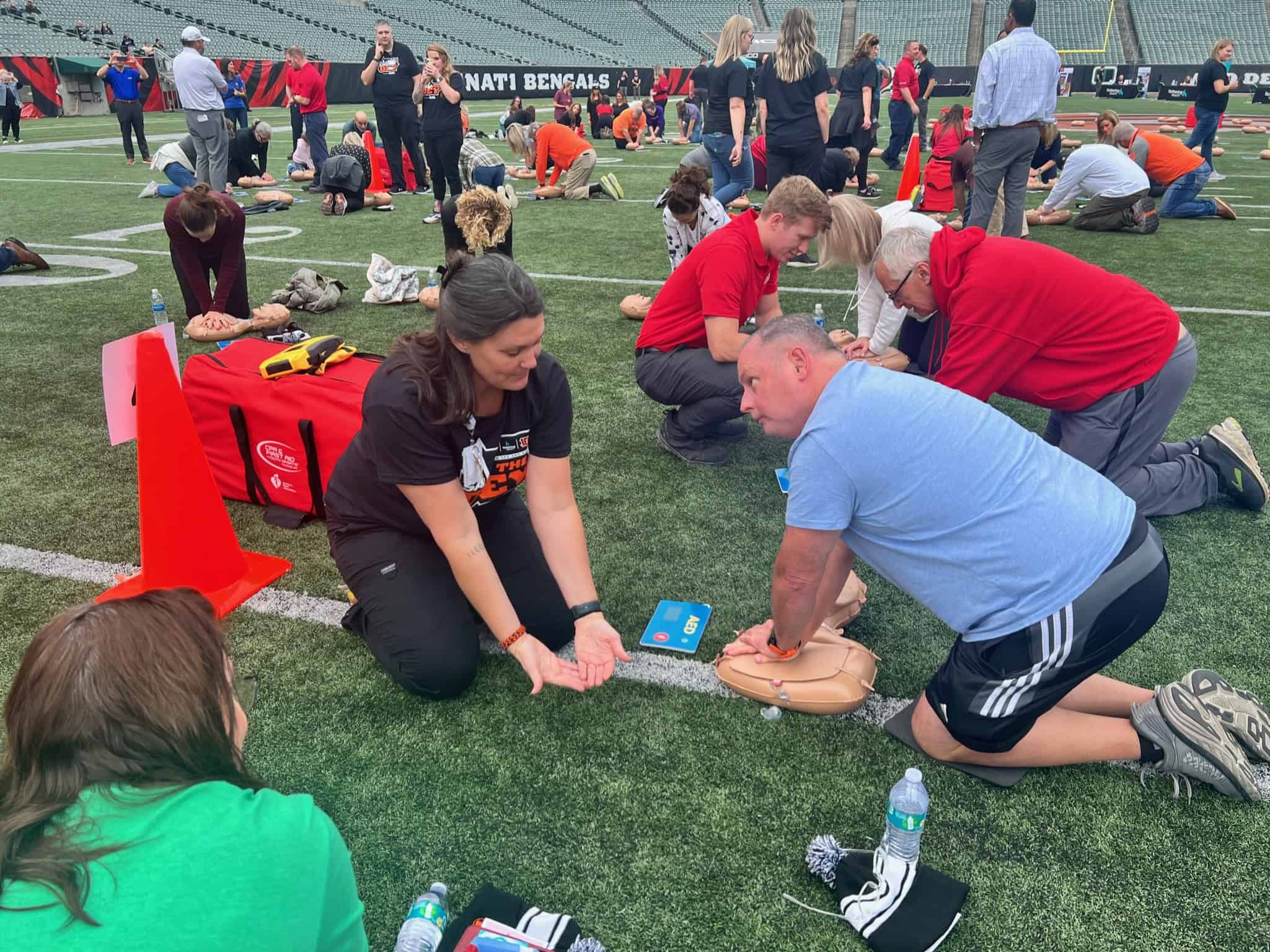 Woman learning CPR at Save the Dey event