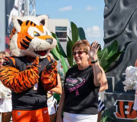 DeAnn Gallatin standing next to Who Dey while being honored as Hometown Hero.