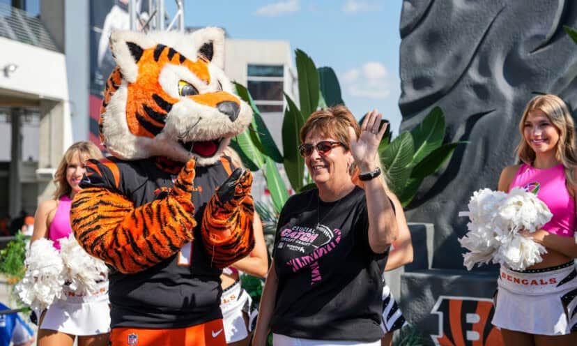 DeAnn Gallatin standing next to Who Dey while being honored as Hometown Hero.