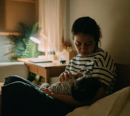 Woman awake with her baby at night