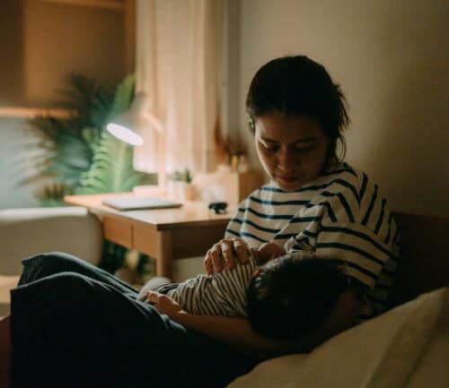 Woman awake with her baby at night