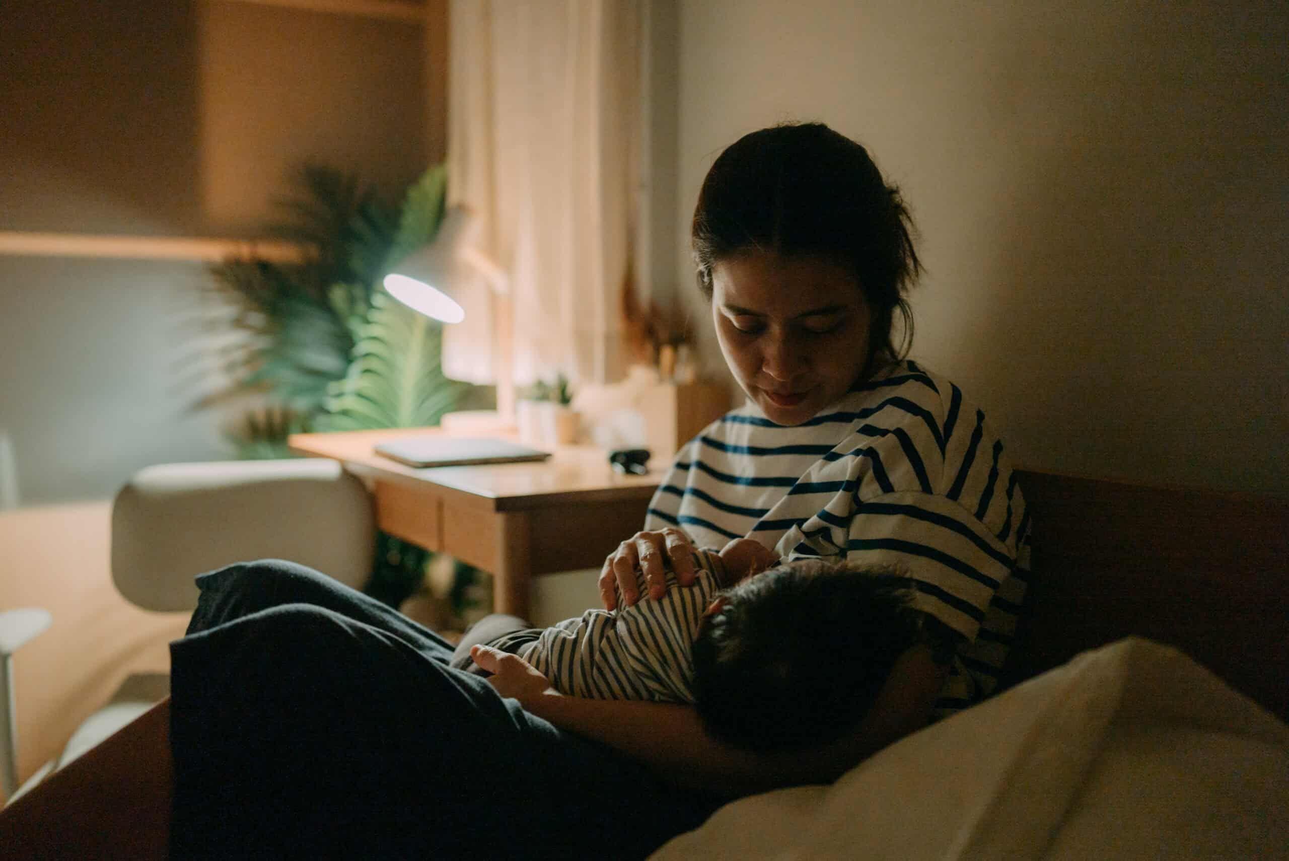 Woman awake with her baby at night