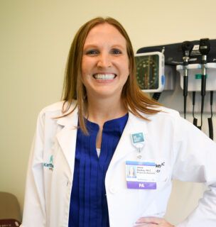 Janna Starkey smiling at camera in patient room