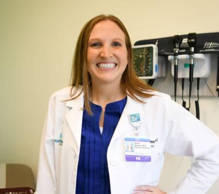 Janna Starkey smiling at camera in patient room