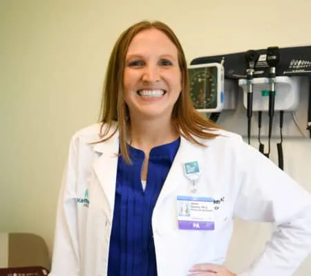 Janna Starkey smiling at camera in patient room