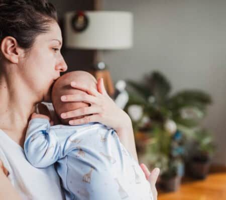 Woman kissing her baby's head