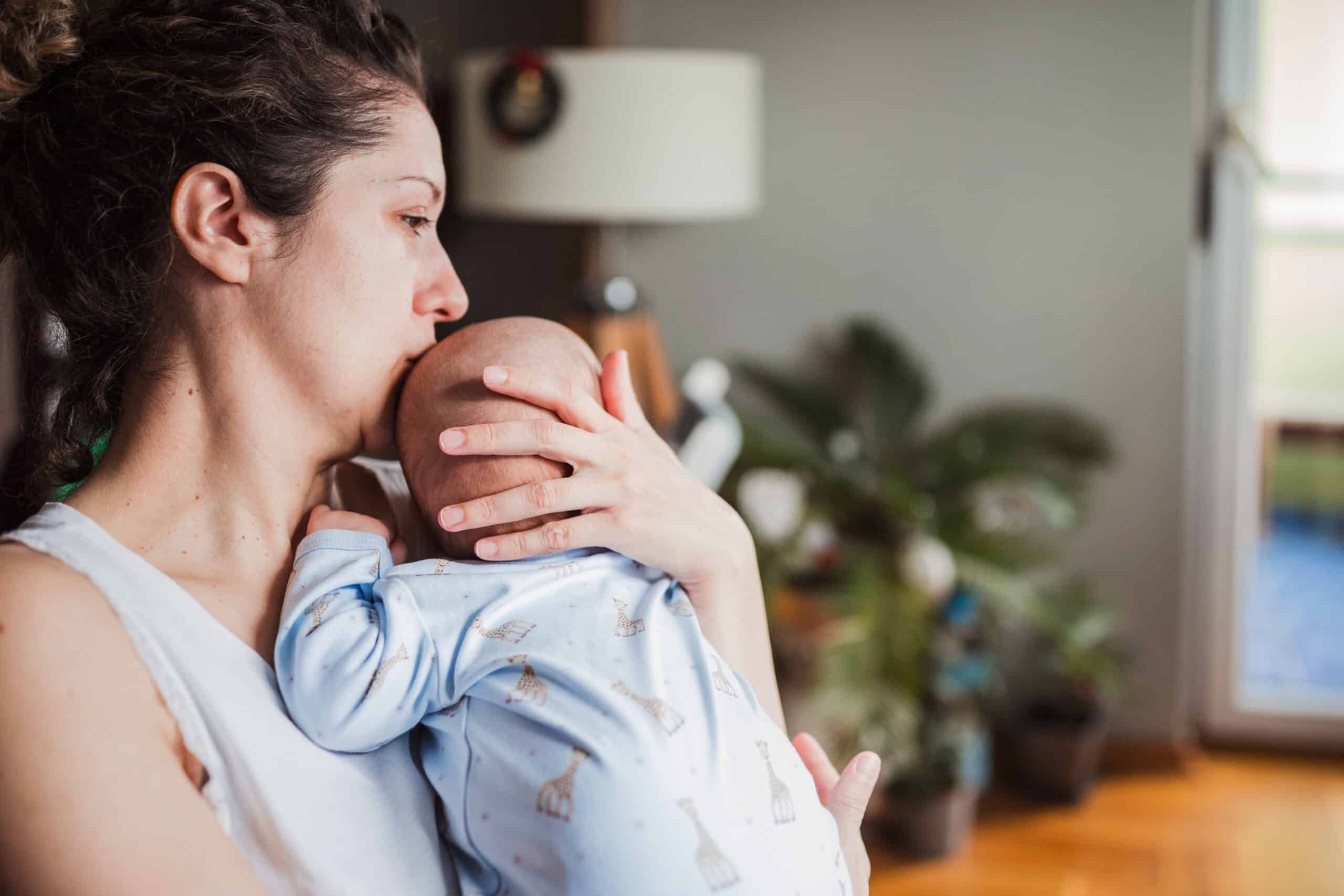 Woman kissing her baby's head