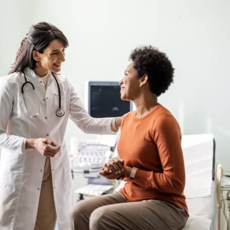 Female primary care provider reassuring a patient