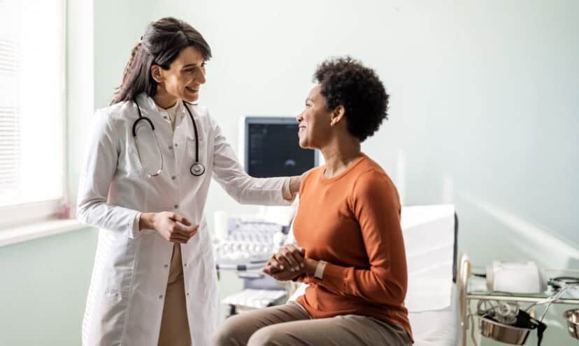 Female primary care provider reassuring a patient