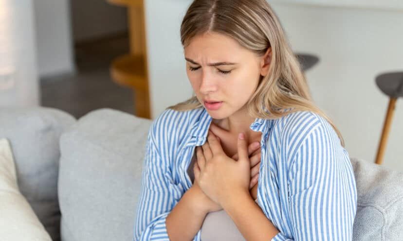 Young woman having chest pain