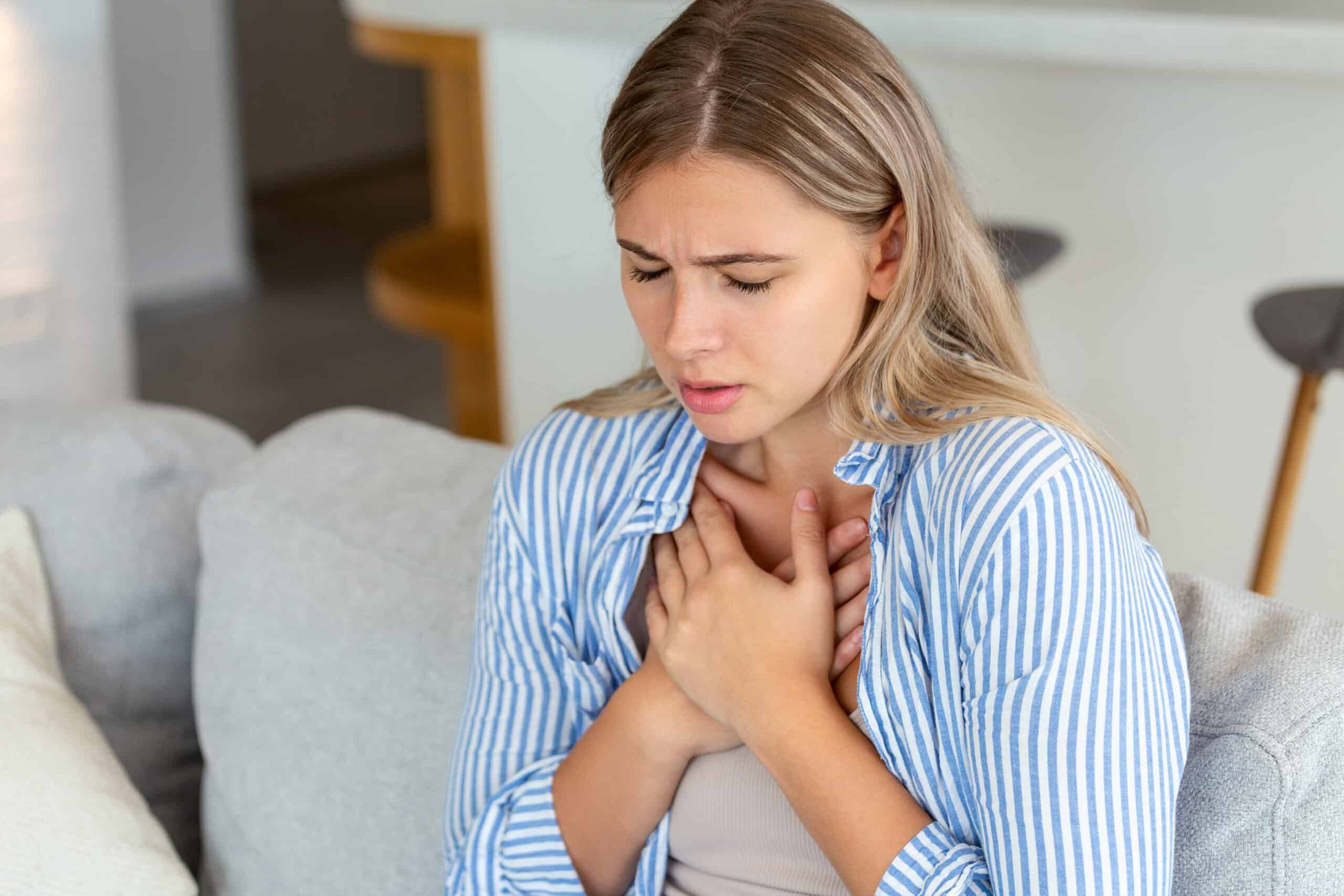 Young woman having chest pain