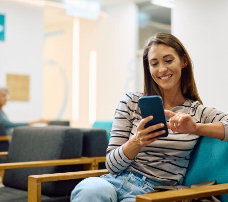 Woman using her phone in waiting room