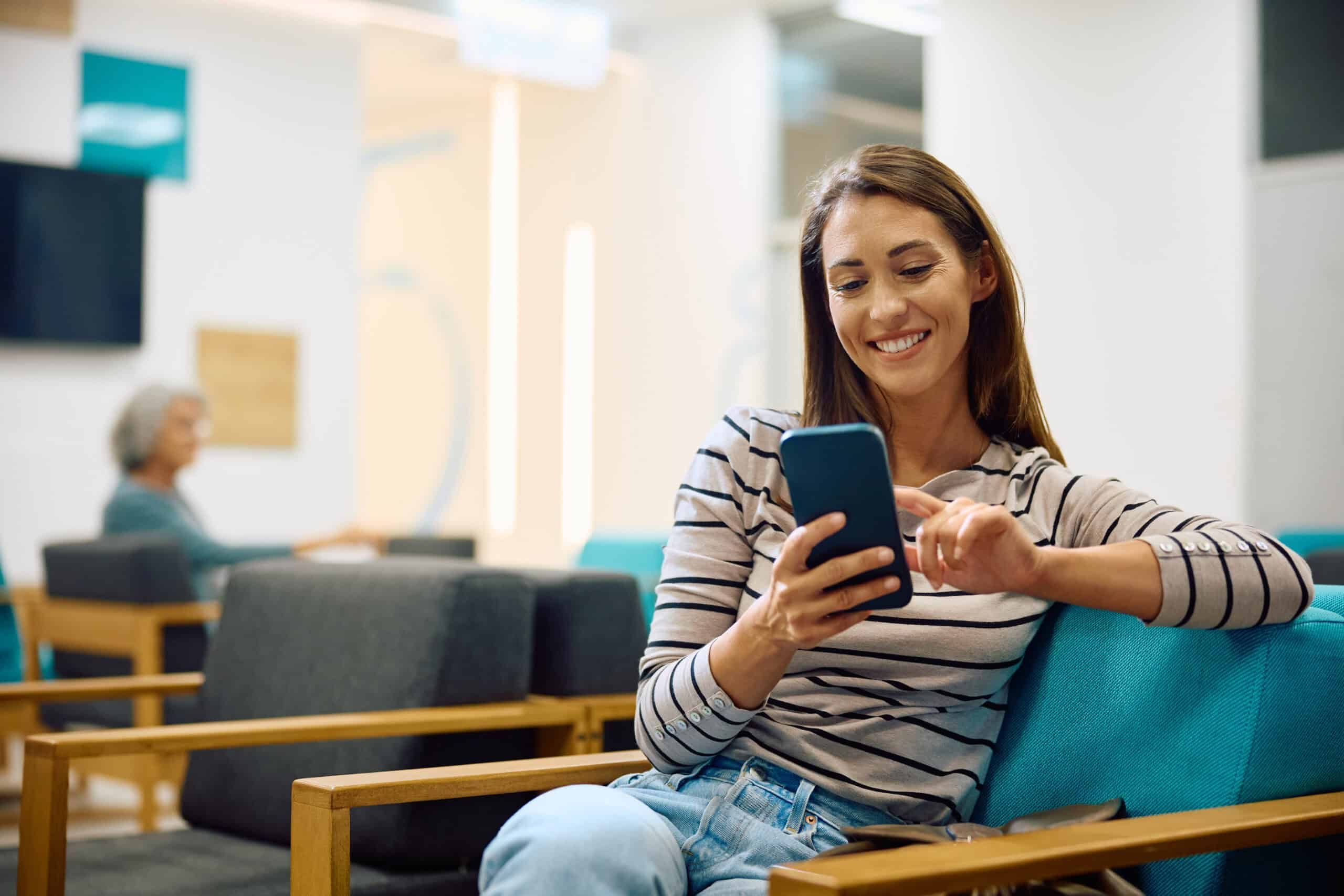 Woman using her phone in waiting room