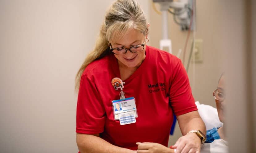 Hand Day 2024 nurse evaluating patient's hand