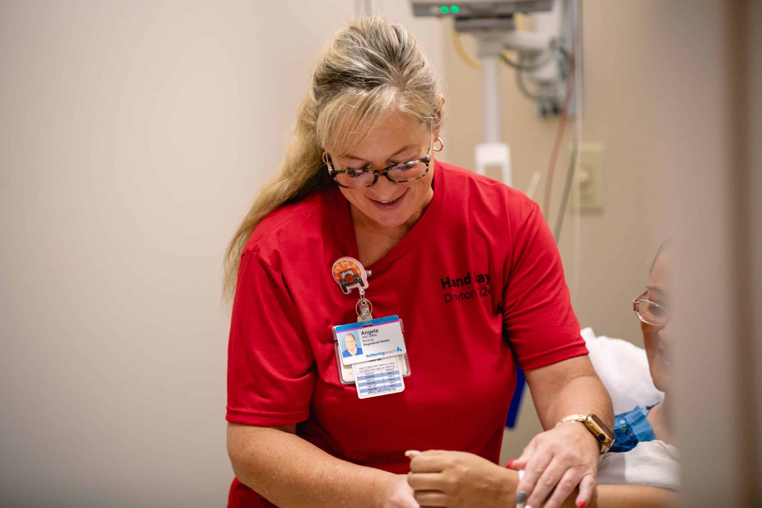 Hand Day 2024 nurse evaluating patient's hand