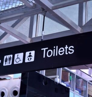 Toilet signs in airport rest room