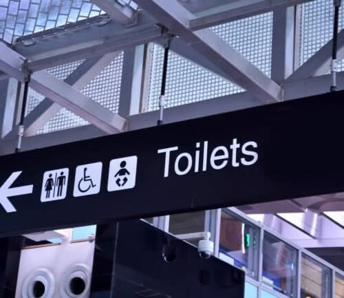 Toilet signs in airport rest room