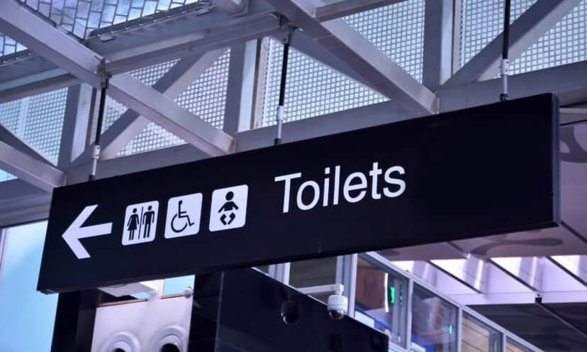 Toilet signs in airport rest room