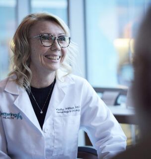 Female doctor talking to a patient, smiling.