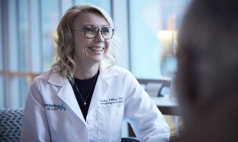 Female doctor talking to a patient, smiling.