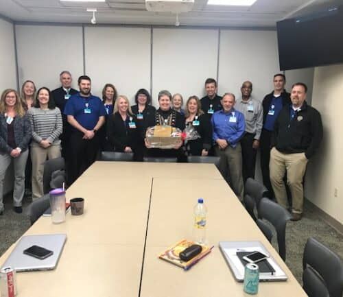 Healthcare team celebrating employee of the month award in conference room