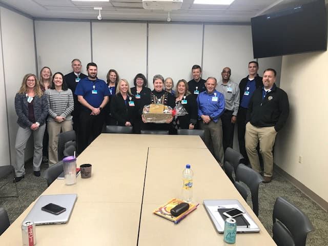Healthcare team celebrating employee of the month award in conference room