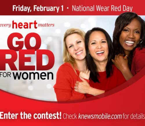 Three women in red clothing embracing and smiling for National Wear Red Day