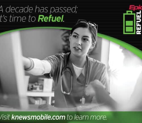 Healthcare worker in scrubs with stethoscope reaching toward camera in hospital setting