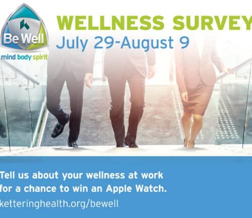 Three business professionals walking up glass staircase toward bright light promoting wellness survey