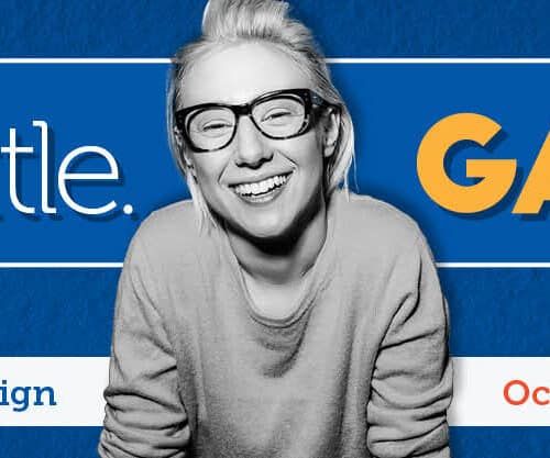 Woman with glasses smiling next to "Give a little. Gain a lot" United Way campaign banner.